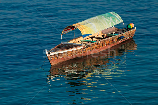 Wooden boat on water Stock photo © EcoPic