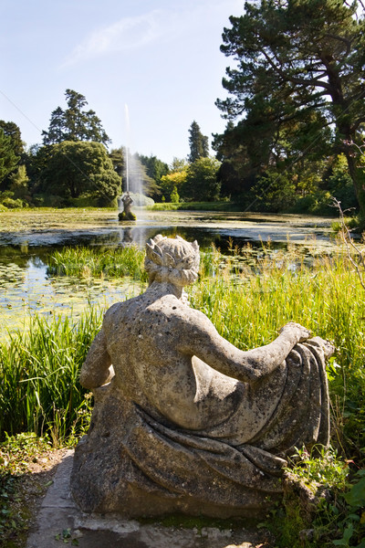 Magnificient gardens at Powerscourt in Ireland with view over the Dolphin pond, Neptune statue and w Stock photo © Eireann