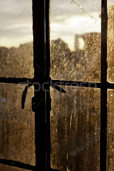 Tarde sol atrás iluminación manchado ventana Foto stock © eldadcarin