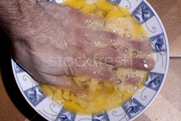 Hand Soaking in Egg Yolk Stock photo © eldadcarin