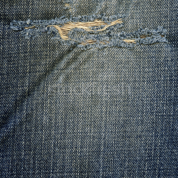 Denim Fabric Texture - Ripped Worn Out Blue Stock photo © eldadcarin