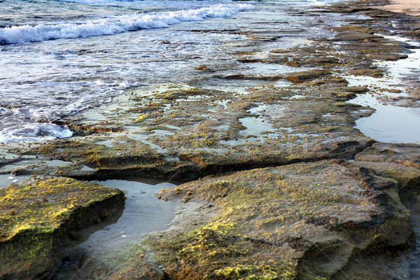 Playa anochecer tiempo cubierto rocas línea Foto stock © eldadcarin