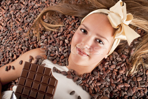 beautiful girl with chocolate on cocoa beans  Stock photo © Elegies