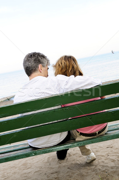 Mature romantic couple on a bench Stock photo © elenaphoto
