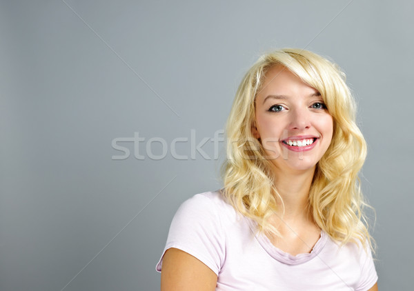 Happy young woman smiling Stock photo © elenaphoto