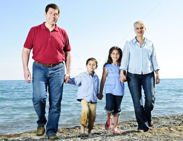 Stock fotó: Boldog · család · portré · négy · sétál · tengerpart · víz