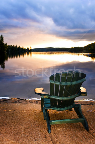Houten stoel zonsondergang strand ontspannen meer hemel Stockfoto © elenaphoto