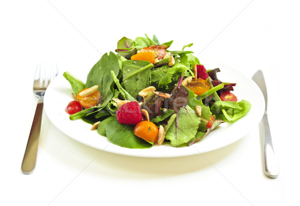 Plate of green salad on white background Stock photo © elenaphoto