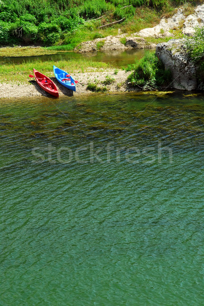 Kayaks on river bank Stock photo © elenaphoto