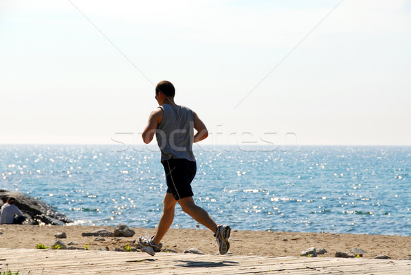 Férfi jogging tengerpart sport egészség sportok Stock fotó © elenaphoto