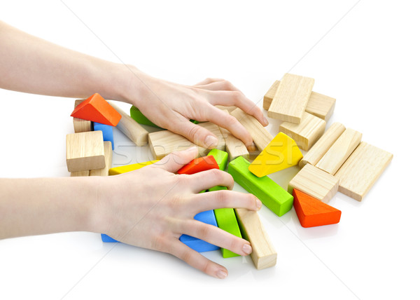 Hands with wooden block toys Stock photo © elenaphoto