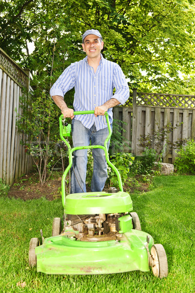 Stock photo: Man mowing lawn