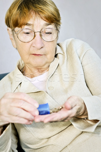 Elderly woman with medication Stock photo © elenaphoto