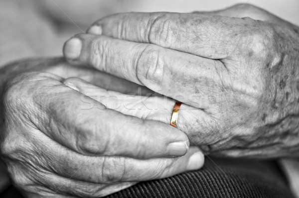 Old hands with wedding band Stock photo © elenaphoto
