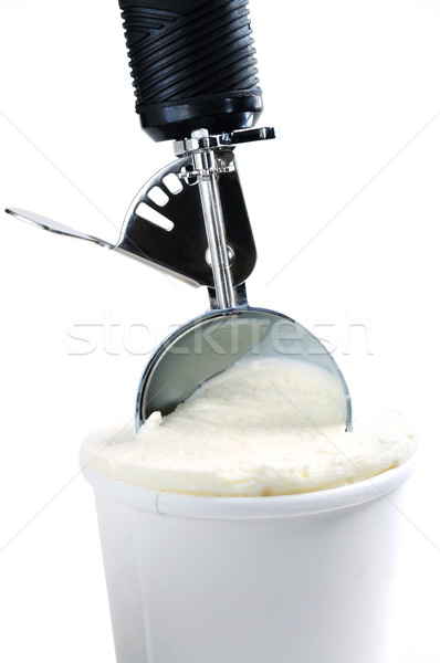 Stock photo: Tub of vanilla ice cream with a scoop