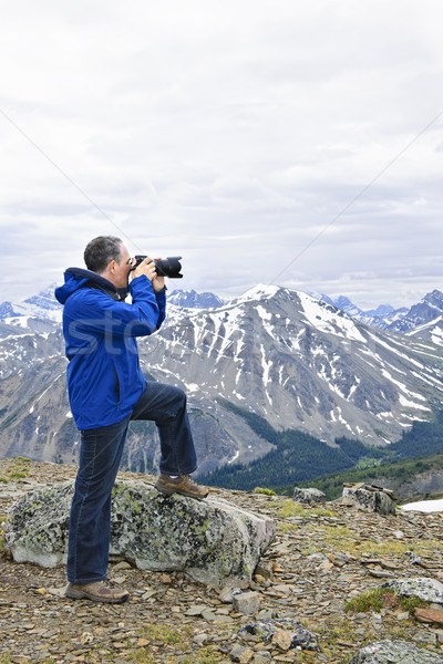 Photographer in mountains Stock photo © elenaphoto