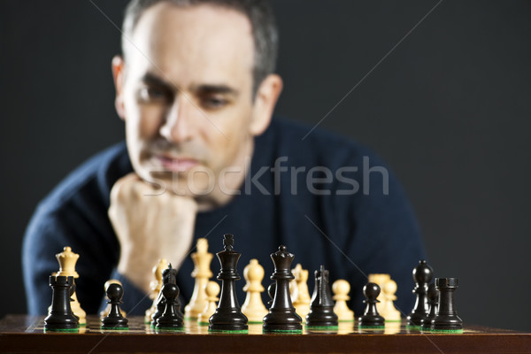 Homme jouer échecs échiquier pense stratégie [[stock_photo]] © elenaphoto