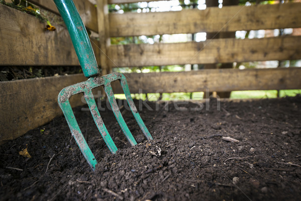 Stock photo: Garden fork turning compost