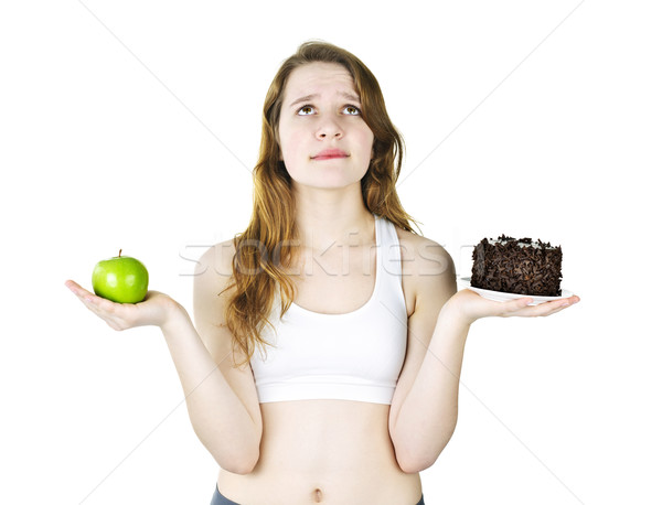Young girl holding apple and cake Stock photo © elenaphoto
