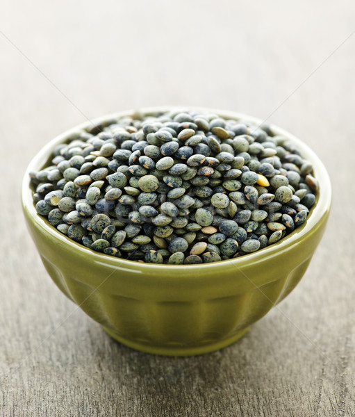 Bowl of uncooked French lentils Stock photo © elenaphoto