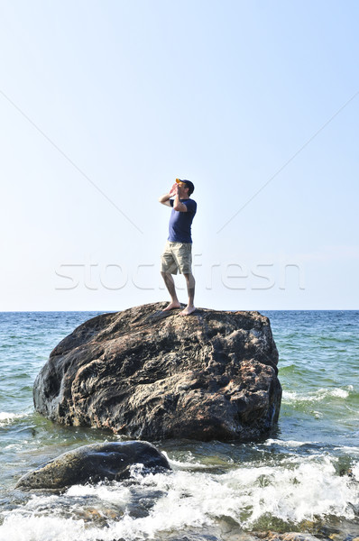 Man stranded on a rock in ocean Stock photo © elenaphoto
