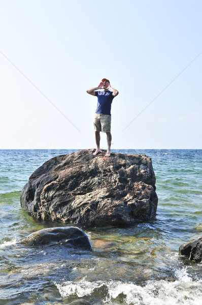 Man stranded on a rock in ocean Stock photo © elenaphoto