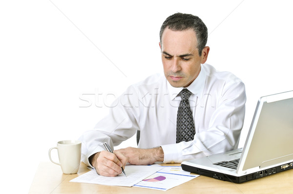 Office worker studying reports Stock photo © elenaphoto