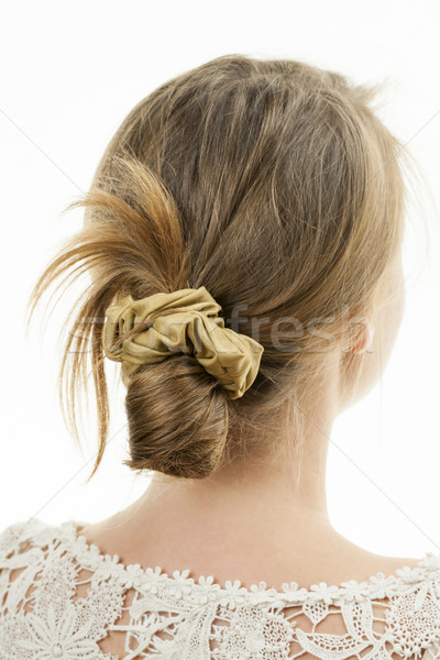 Young woman with casual messy bun hairdo Stock photo © elenaphoto