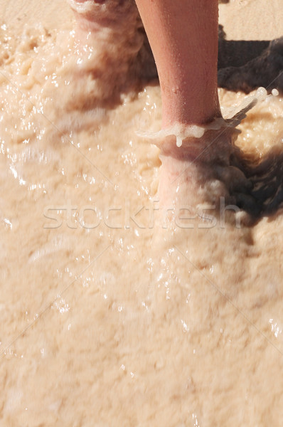 Feet washed in ocean wave Stock photo © elenaphoto