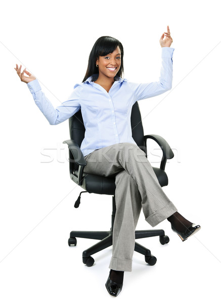 Happy businesswoman sitting on office chair Stock photo © elenaphoto
