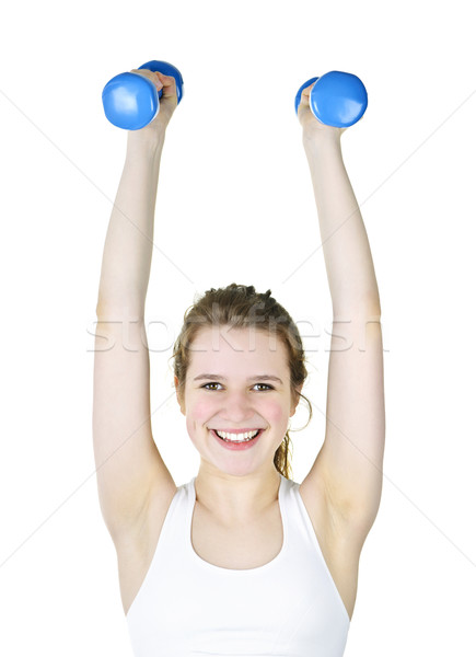 Fit active girl lifting weights for fitness Stock photo © elenaphoto