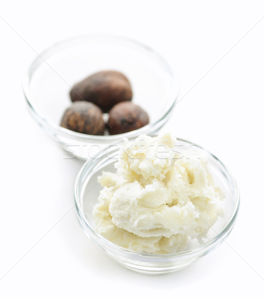 Shea butter and nuts in bowls Stock photo © elenaphoto
