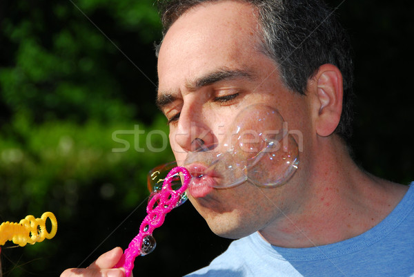 Man blowing bubbles Stock photo © elenaphoto