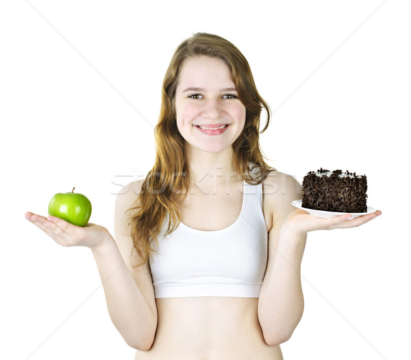 Young girl holding apple and cake Stock photo © elenaphoto