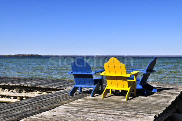 Chairs on wooden dock at lake Stock photo © elenaphoto