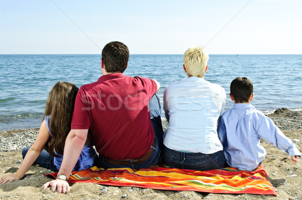 Family sitting at beach Stock photo © elenaphoto