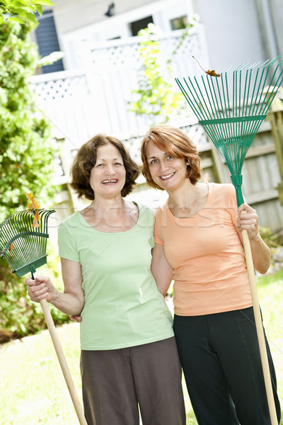 Women with rakes in garden Stock photo © elenaphoto