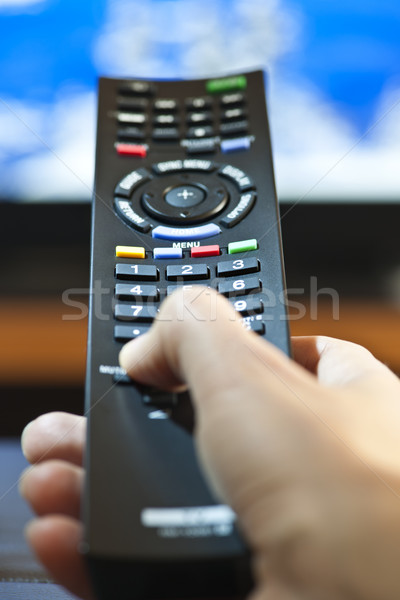 Hand with television remote control Stock photo © elenaphoto