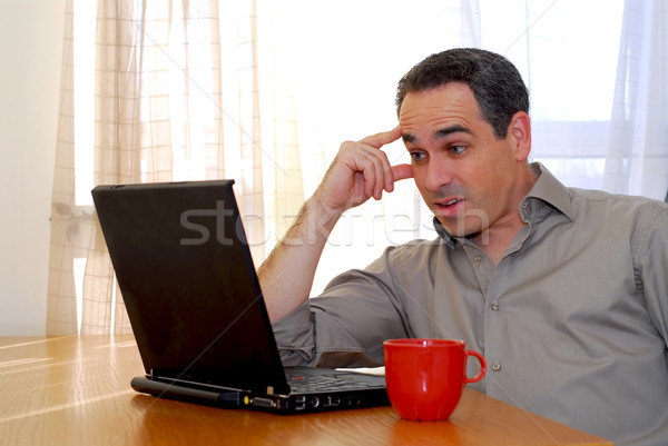 Adam dizüstü bilgisayar oturma büro bakıyor iş Stok fotoğraf © elenaphoto