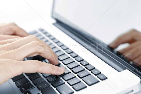 Hands typing on laptop keyboard Stock photo © elenaphoto
