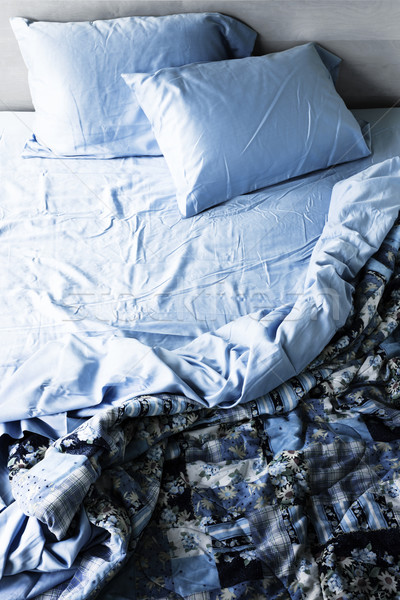 Unmade bed and bedding Stock photo © elenaphoto