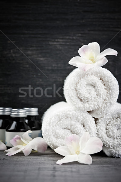 Rolled up towels and products at spa Stock photo © elenaphoto