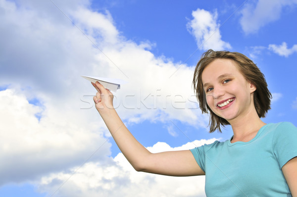 Young girl holding paper airplane Stock photo © elenaphoto
