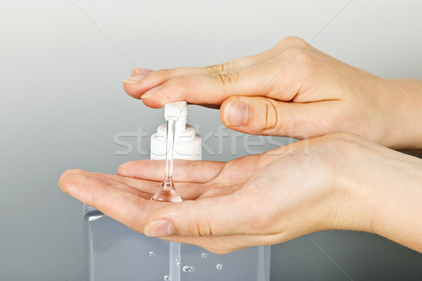 Hands applying sanitizer gel Stock photo © elenaphoto