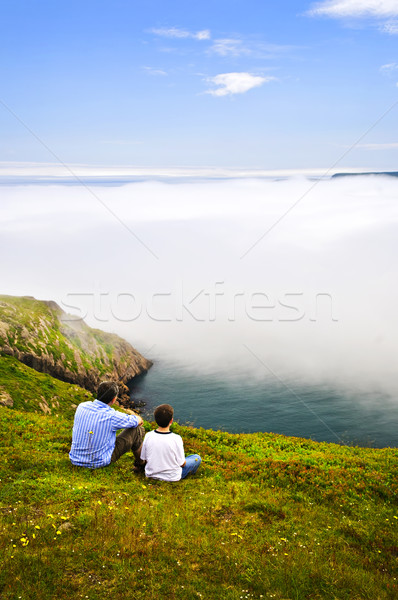 Apa fia óceán part néz ködös kilátás Stock fotó © elenaphoto