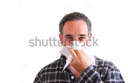 Man with cold blowing nose Stock photo © elenaphoto