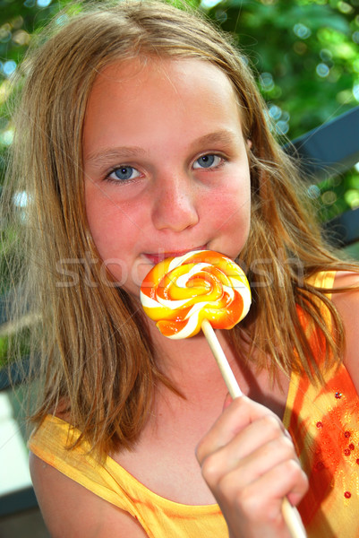 Girl with lollipop Stock photo © elenaphoto
