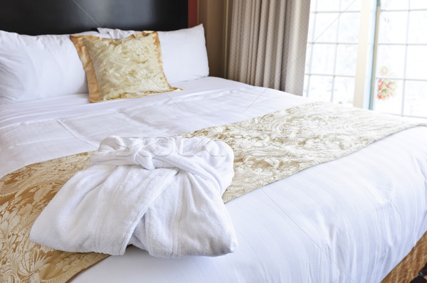 Hotel bed with bathrobe Stock photo © elenaphoto