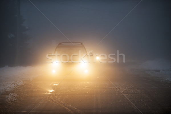 Headlights of car driving in fog Stock photo © elenaphoto