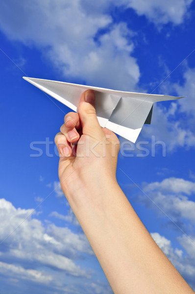 Hand holding paper airplane Stock photo © elenaphoto